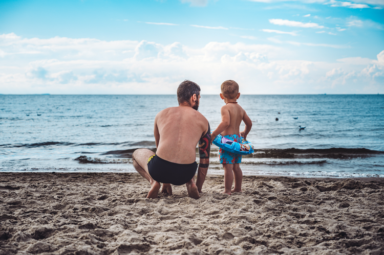 Father and son on beach - Is it safe to swim in red tide